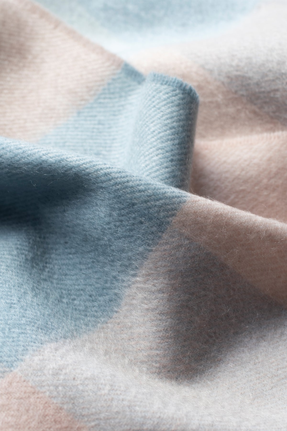 Close-up of 3 Square Cashmere Scarf in Seashell showing soft twill weave texture in dusty blue and blush pink tones