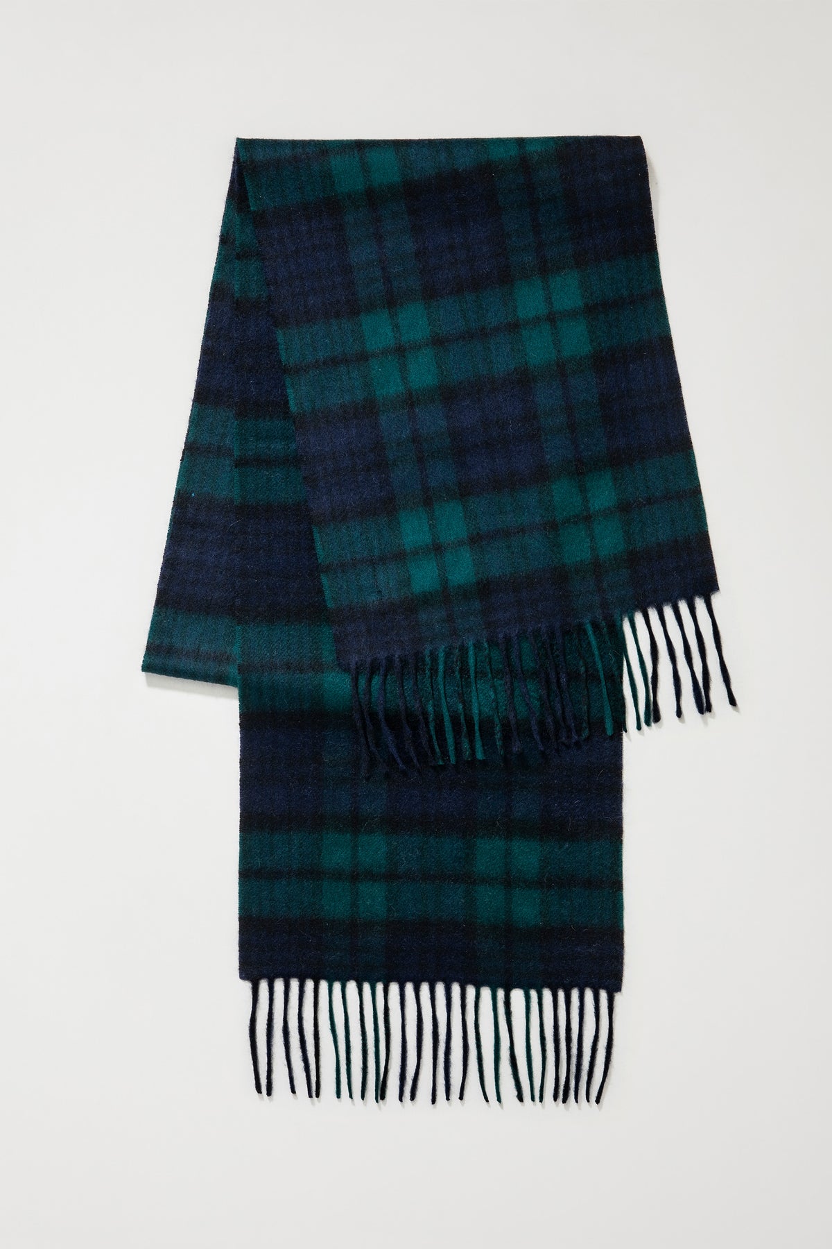Heritage Tartan Cashmere Scarf in Blackwatch folded flat showing full tartan pattern in navy and green with fringed ends