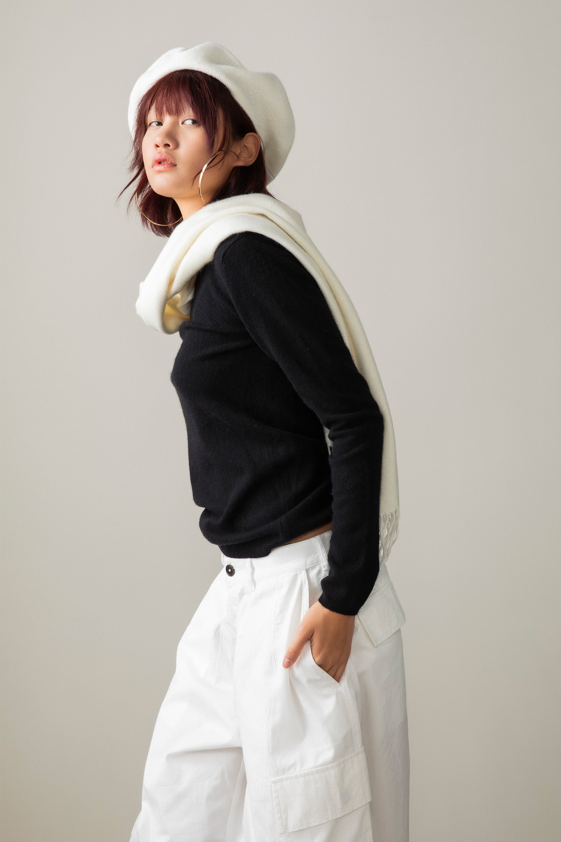 Solid Cashmere Wide Scarf in Soft Cream draped over shoulders, side profile showing its length against a black sweater
