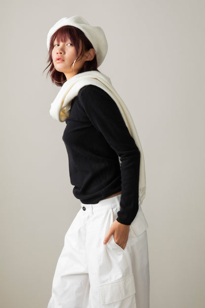 Solid Cashmere Wide Scarf in Soft Cream draped over shoulders, side profile showing its length against a black sweater
