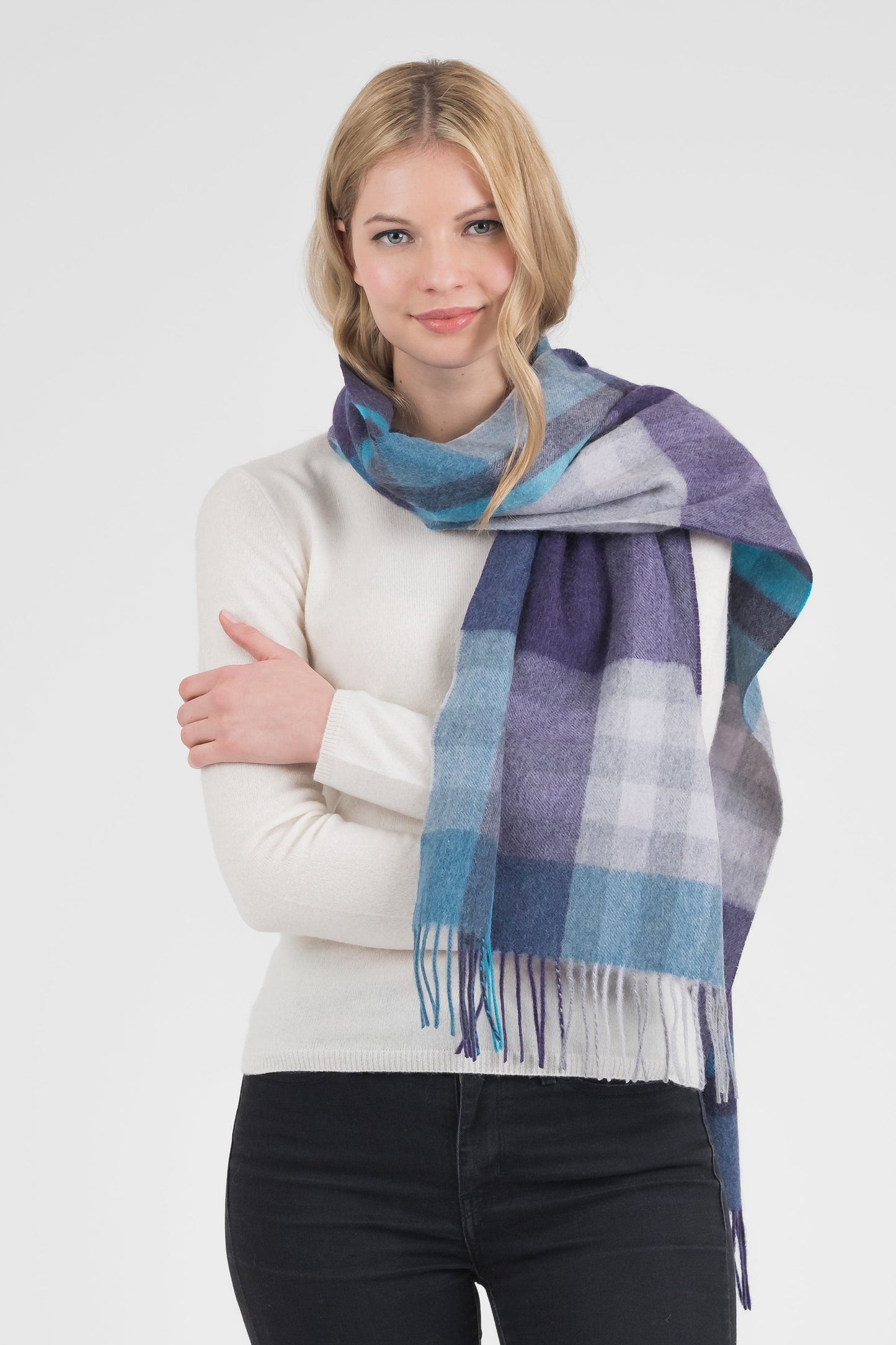 Tartan 2 Cashmere Wide Scarf in Blue worn draped over shoulders, featuring purple, teal, and white check pattern with fringed ends