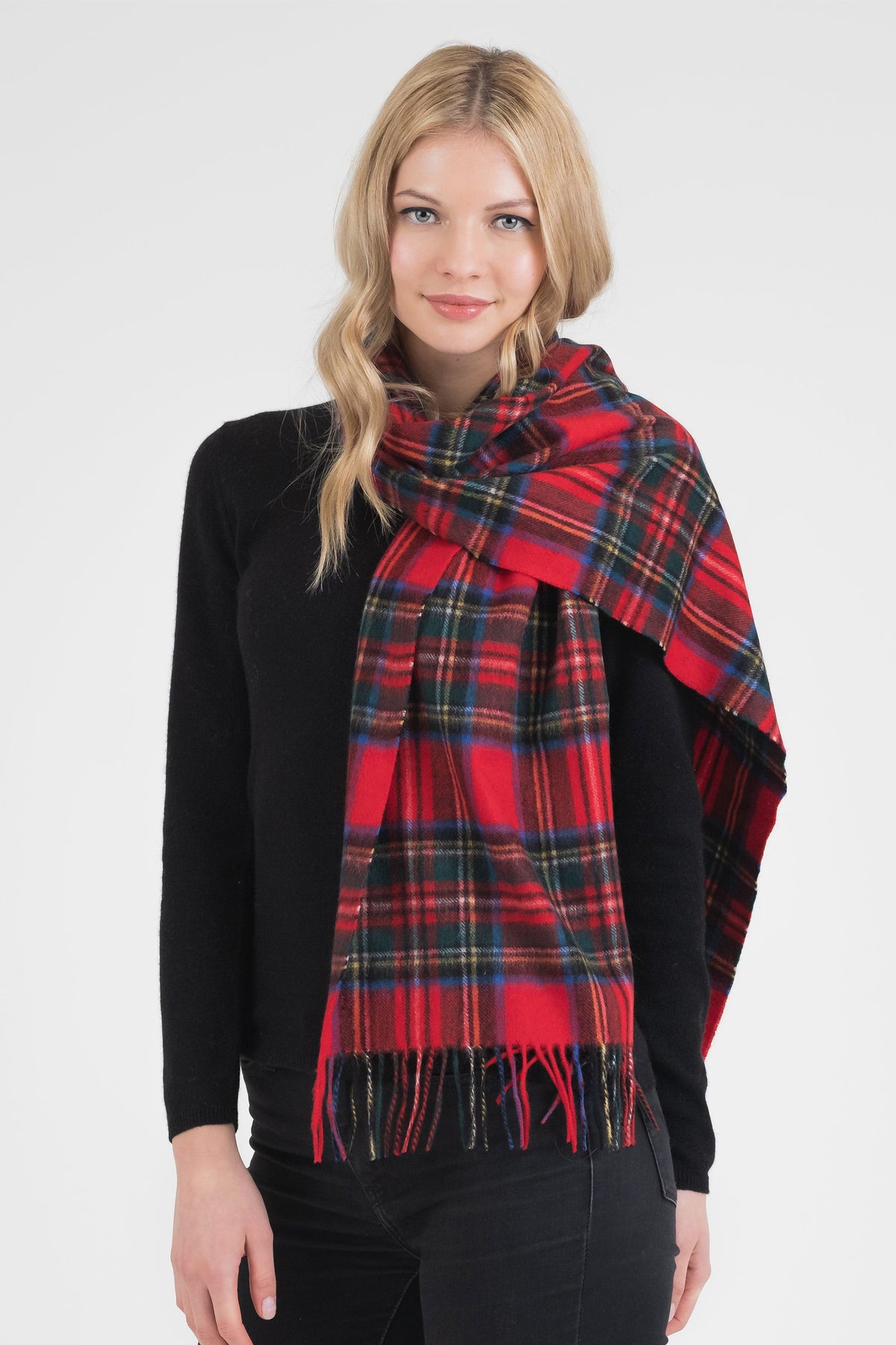 Heritage Tartan Cashmere Wide Scarf in Official Royal Stewart red plaid with fringed ends, worn draped over a black sweater
