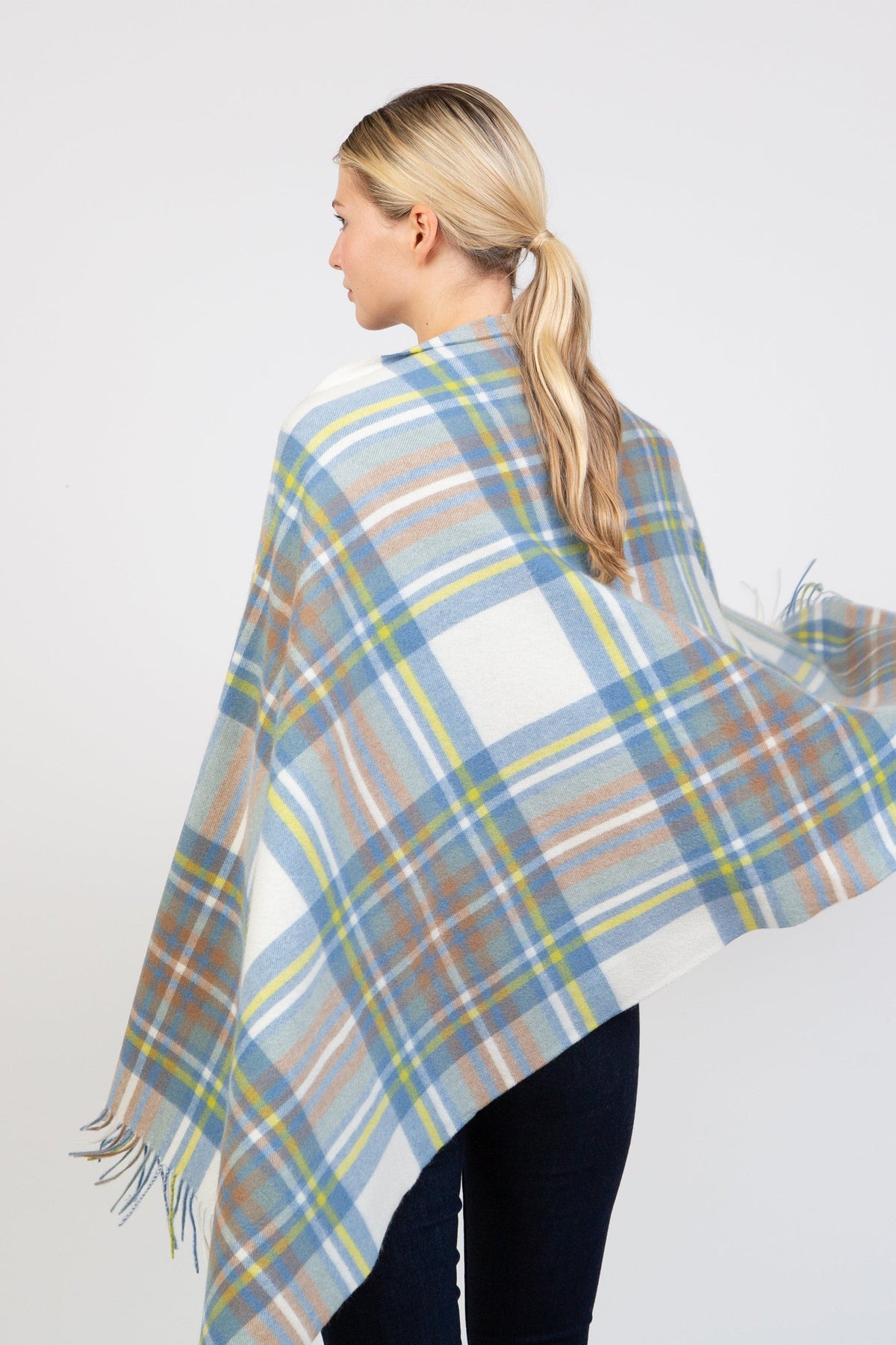 Back view of Heritage Tartan Cashmere Stole in Muted Blue Stewart, showing full plaid pattern with fringed edges draped over shoulders