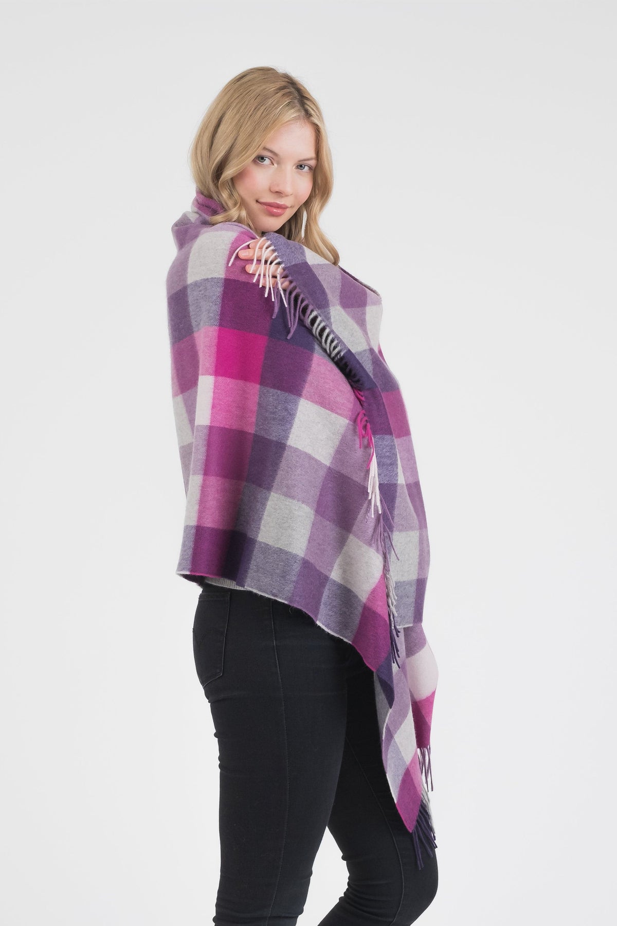 5 Square Check Cashmere Stole in Purple worn draped over shoulders, featuring bold plaid pattern in purple, pink, and grey with fringed edges