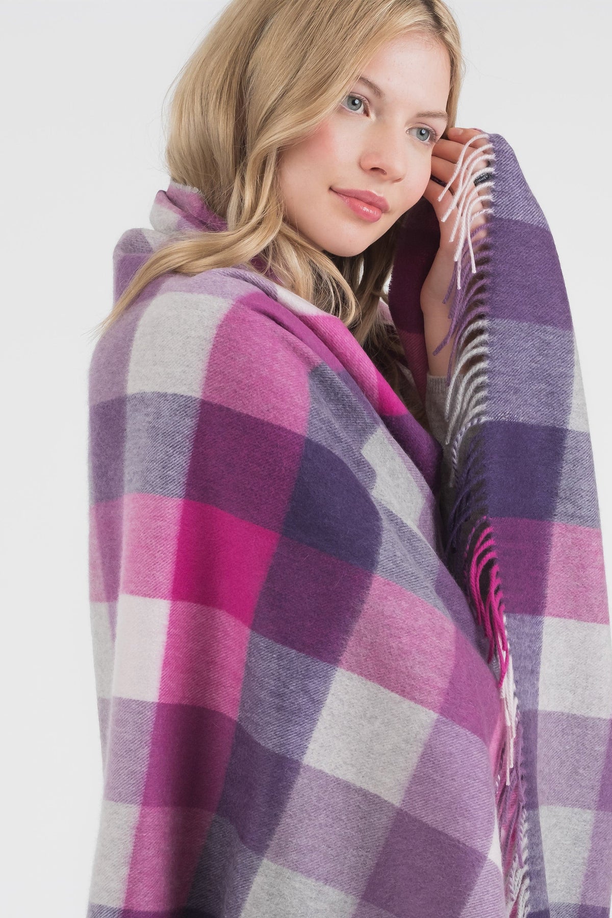Model wrapped in 5 Square Check Cashmere Stole in Purple, showing the soft check pattern and fringed edge detail