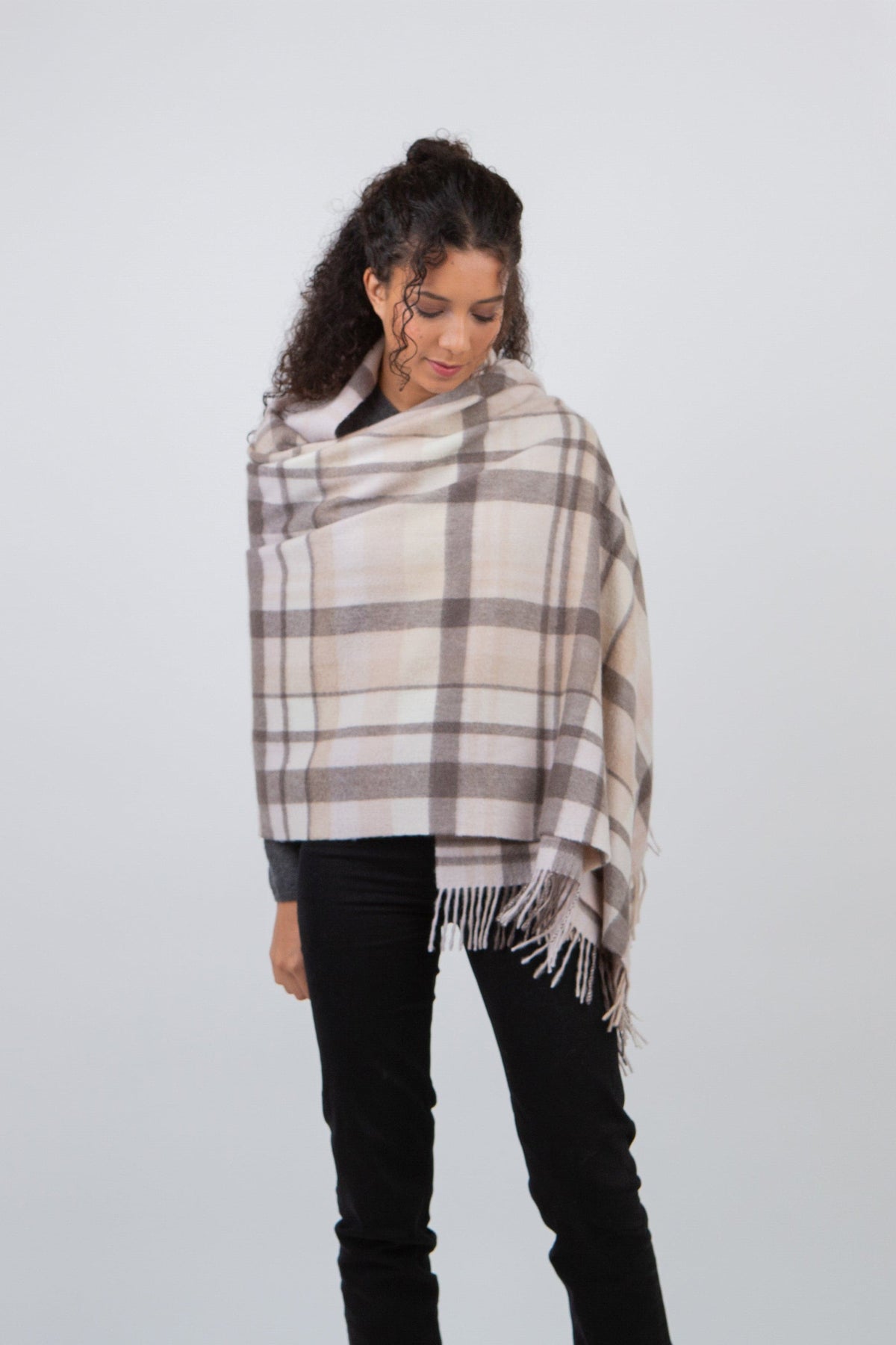 Square Check Cashmere Stole in Natural worn draped over shoulders, cream and grey plaid pattern with fringed edges