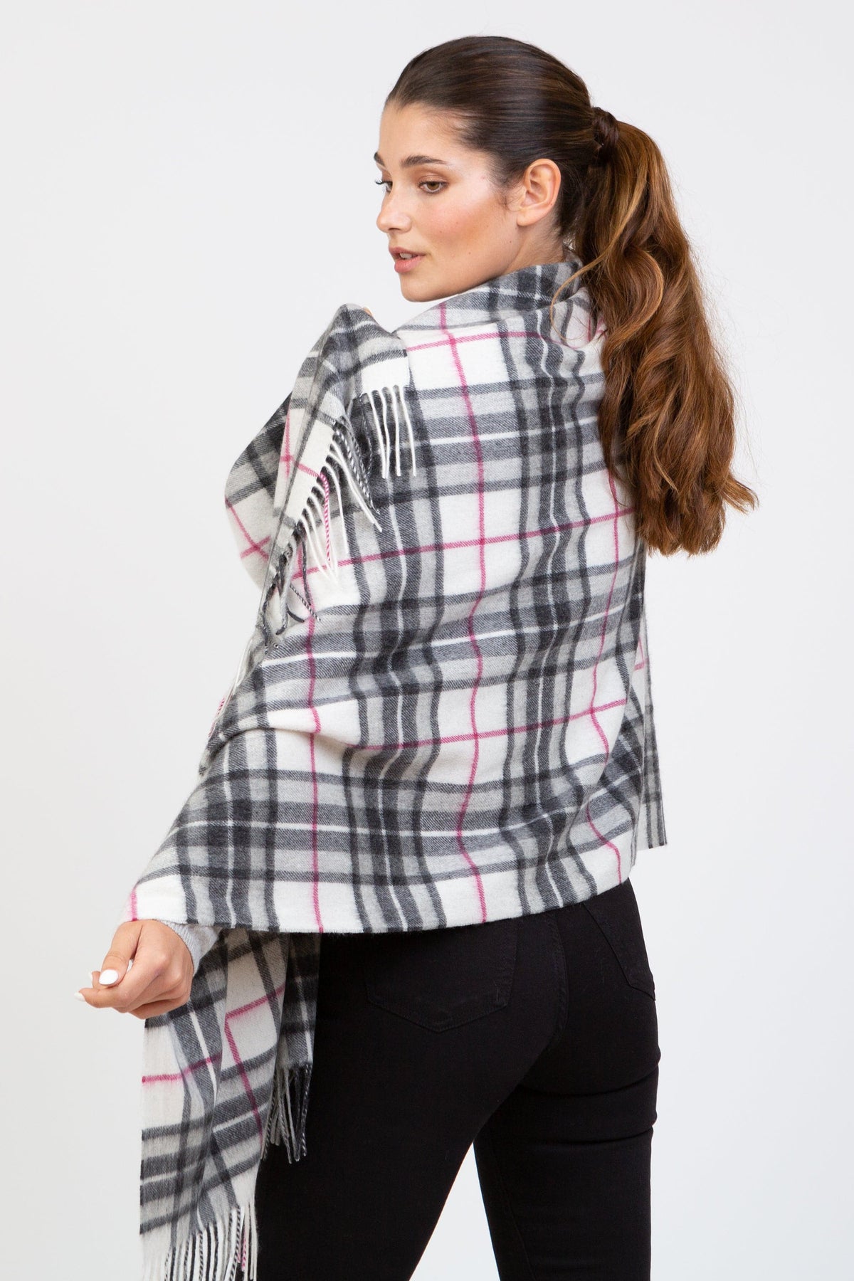Back view of model wearing Scotty Thompson Cashmere Stole in White, showing full tartan pattern in grey, black, and pink