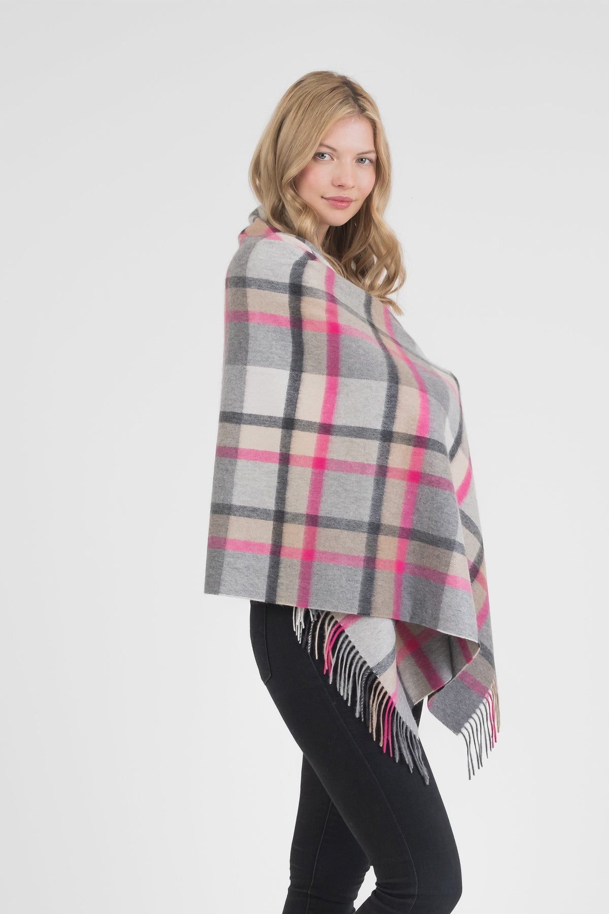 Princeton Check Cashmere Stole in Pink worn as a wrap, featuring grey, beige, and hot pink tartan pattern with fringed edges