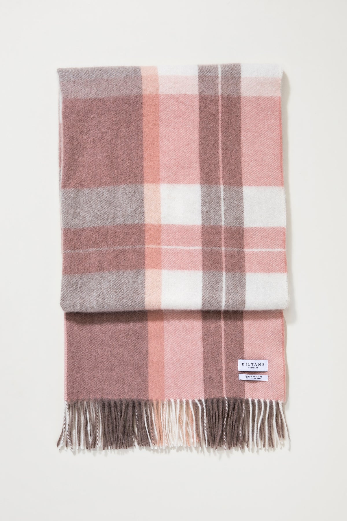 Contemporary Check Cashmere Stole - Cameo folded flat showing pink, grey, and white plaid pattern with fringed ends and Kiltane label