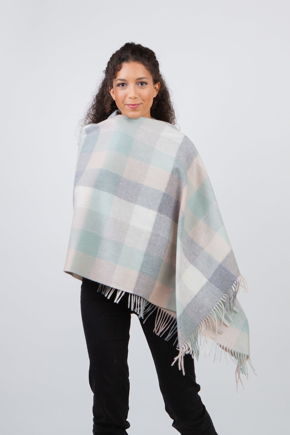 5 Square Check Cashmere Stole in Brume worn as a wrap, featuring soft pastel check pattern in mint, grey, and cream with fringed edges