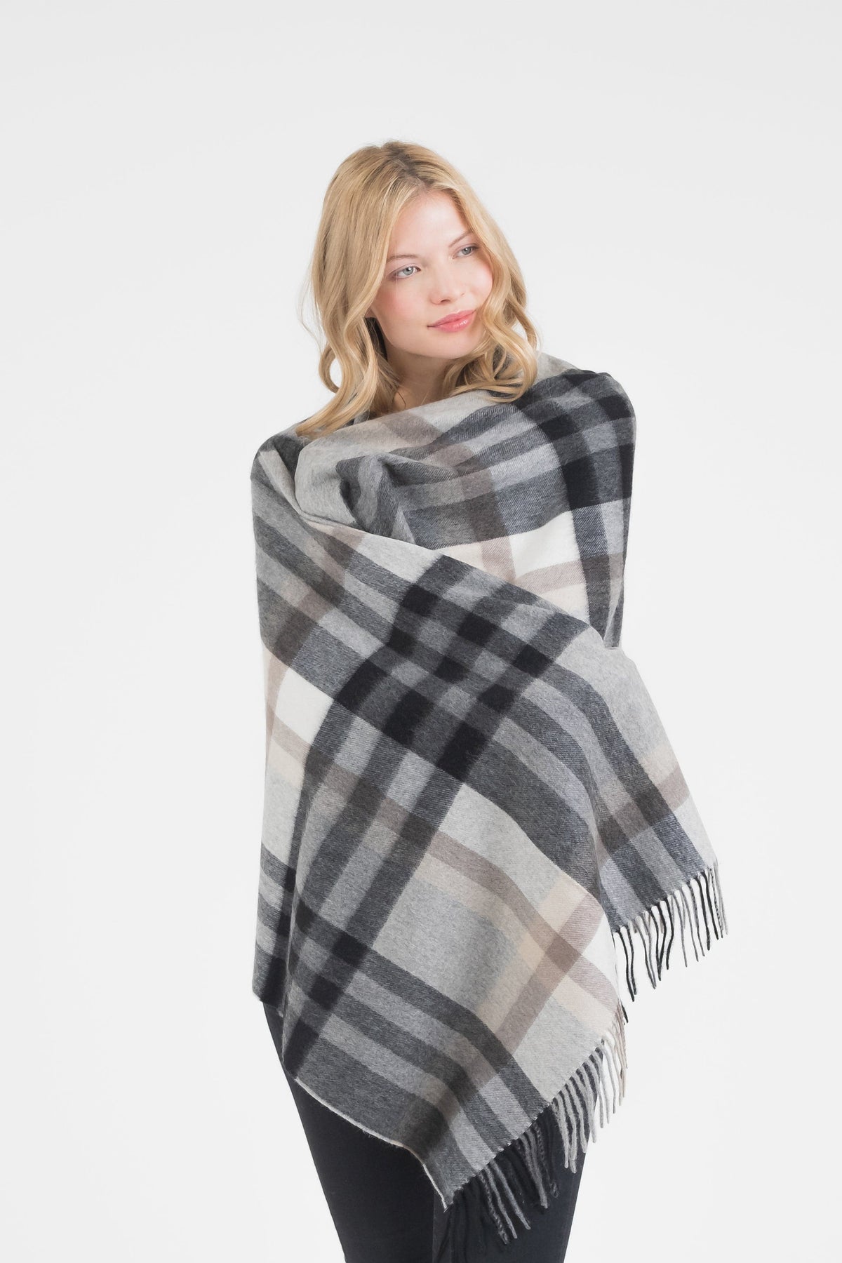Model wrapped in Tartan 2 Cashmere Stole in Black Grey, showing the oversized drape and fringed edges