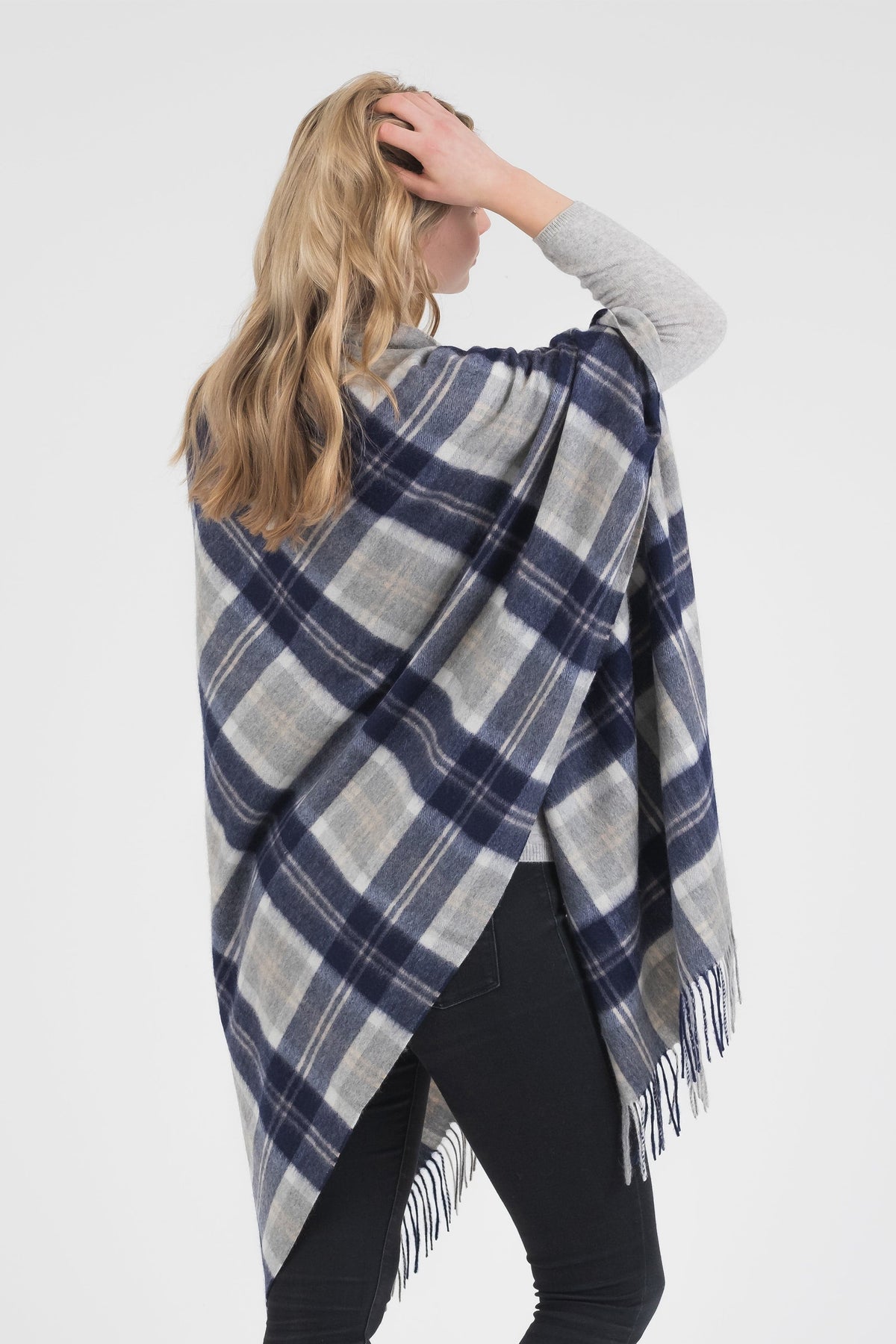 Back view of Heritage Tartan Cashmere Stole in Silver Bannockbane draped over shoulders, showing navy and grey plaid pattern with fringe hem