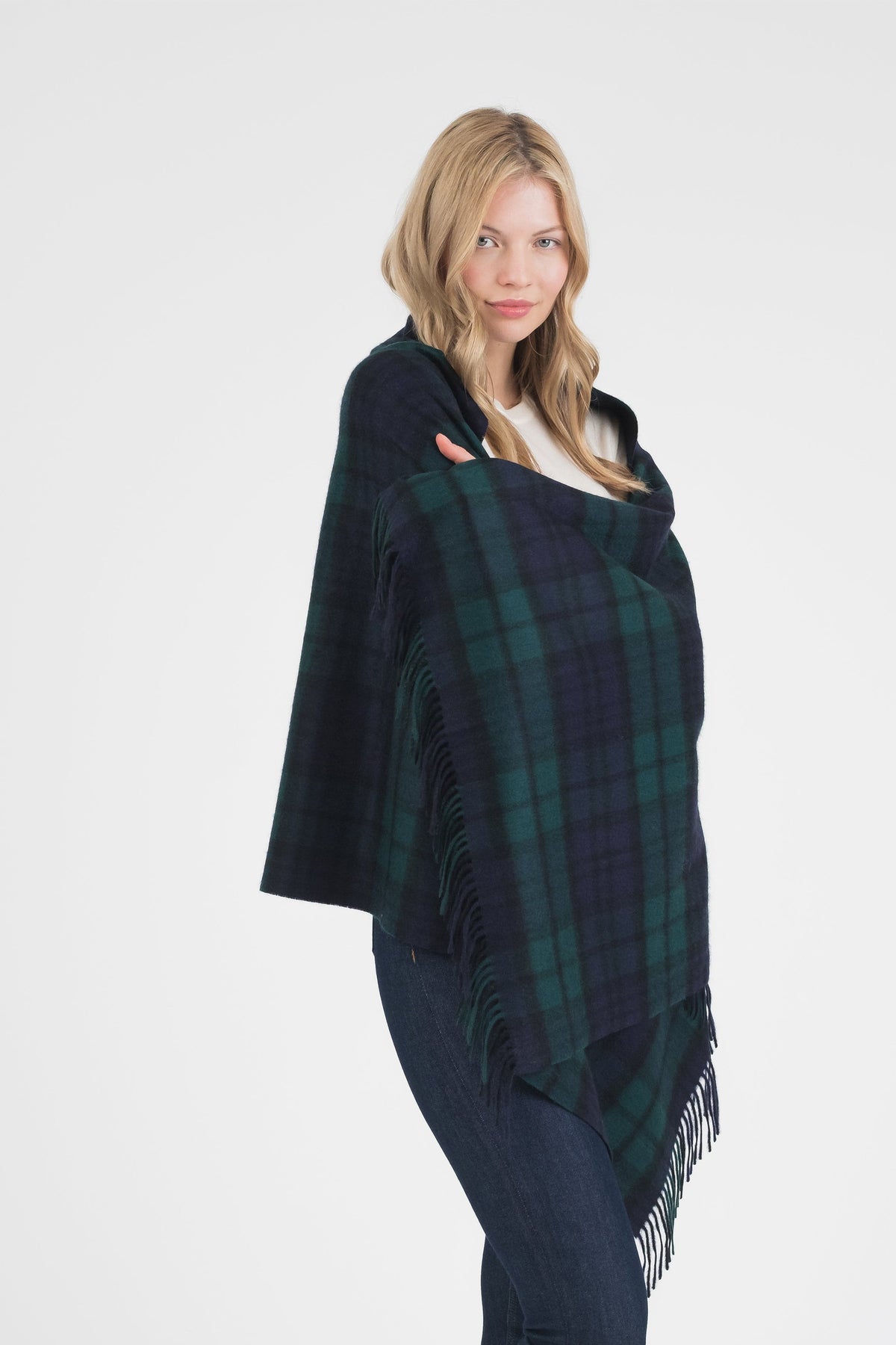 Heritage Tartan Cashmere Stole in Blackwatch draped over shoulders, navy and green plaid pattern with fringed edges