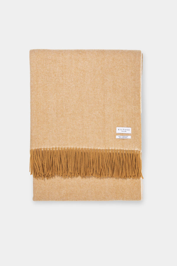 Kiltane Herringbone Lambswool Throw in Amber Gold, neatly folded showing herringbone weave pattern and fringed edge