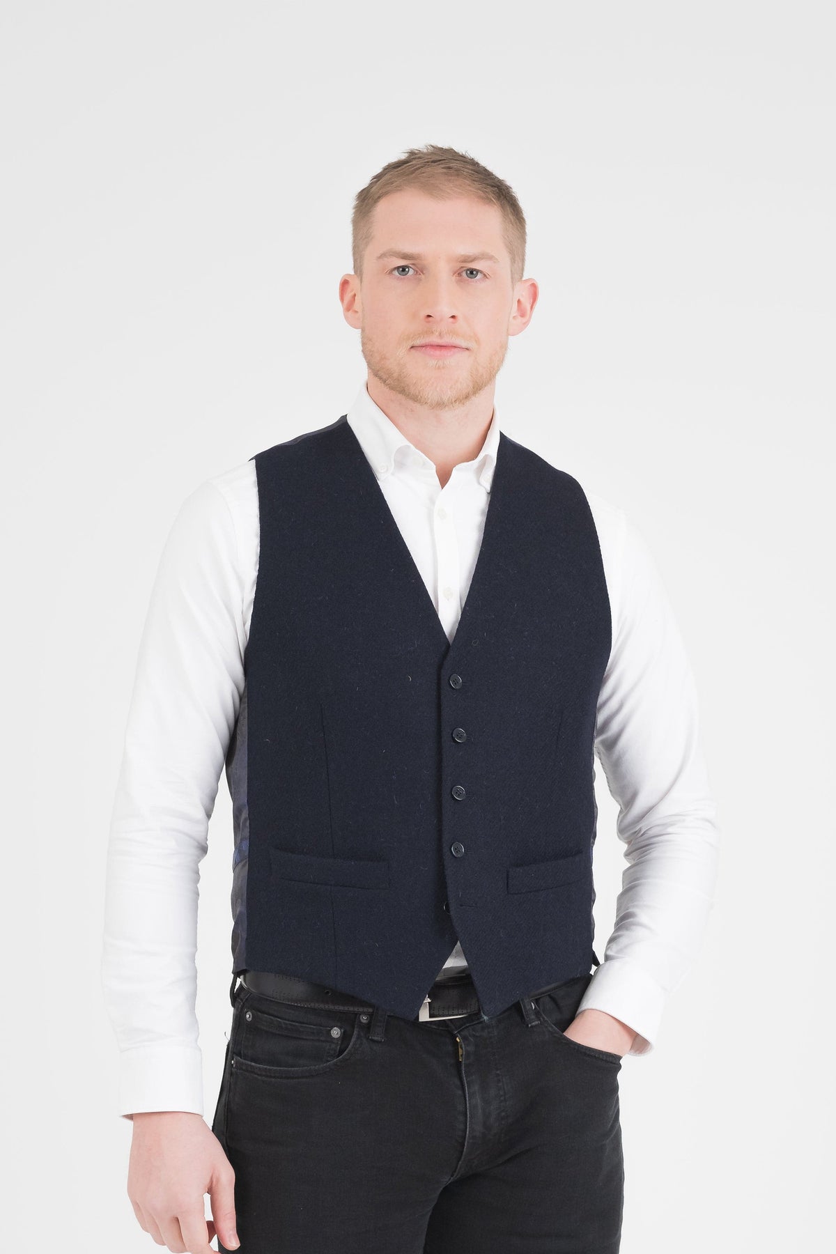 Harris Tweed Iain Waistcoat in Dark Navy Twill Solid, front view on model styled with white shirt and black jeans