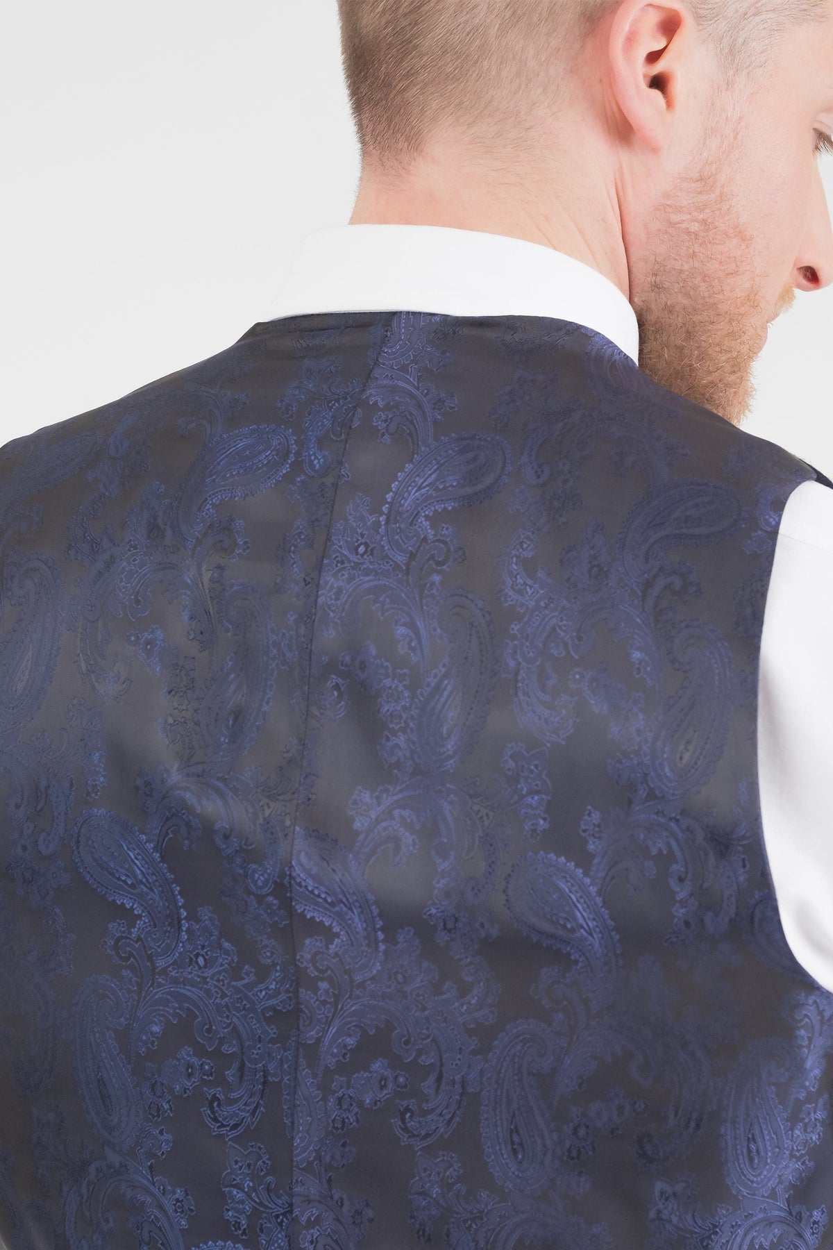 Back view of Harris Tweed Iain Waistcoat showing navy paisley lining fabric worn over a white dress shirt