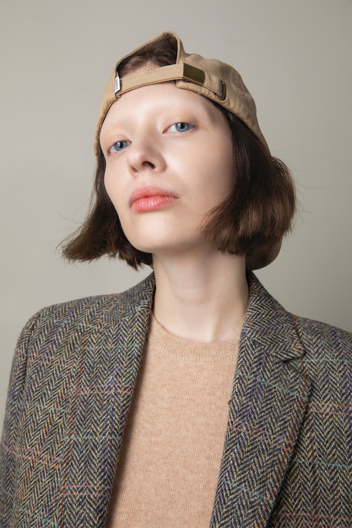 Women's Harris Tweed Janice Blazer in Natural Check worn open over a camel sweater, showing herringbone weave and lapel detail