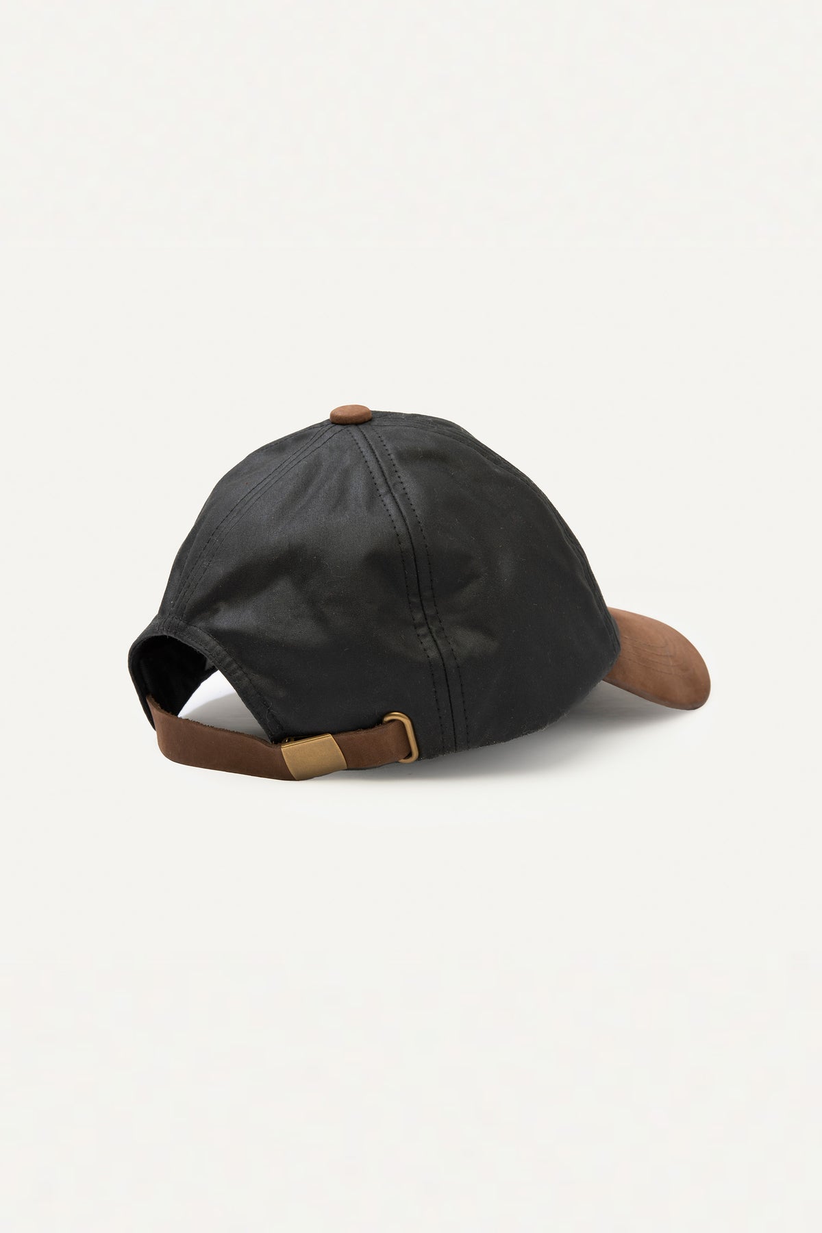 Back view of Wax Baseball Cap in black showing brown leather adjustable strap with brass buckle closure