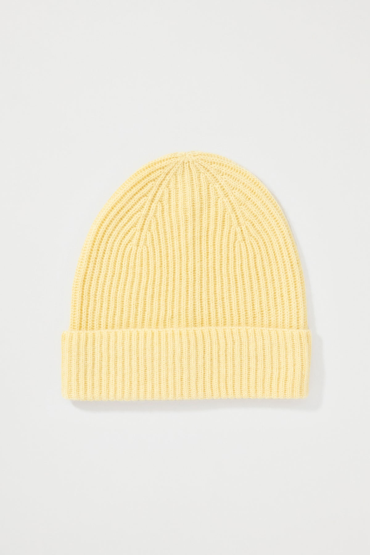 Unisex Cashmere Ribbed Beanie Hat in lemon yellow, flat lay showing ribbed knit texture and folded cuff detail