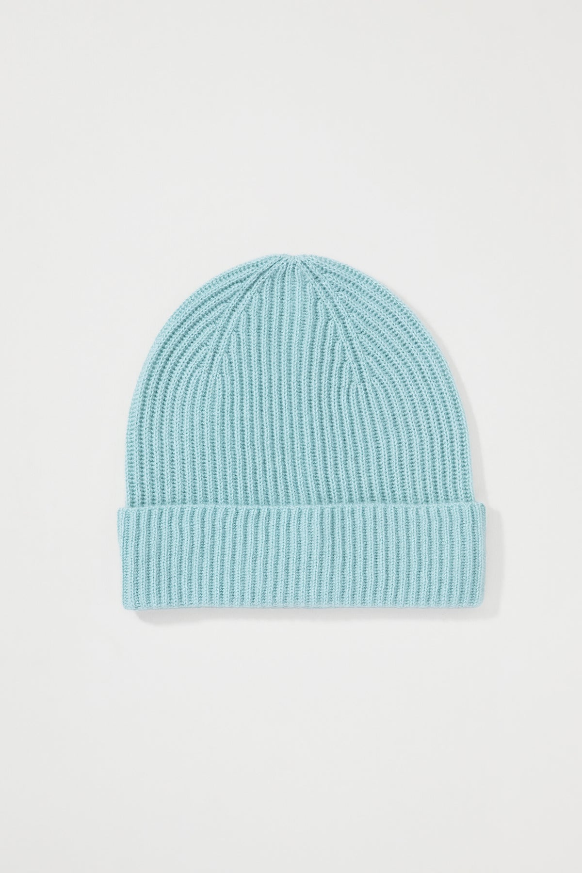 Unisex Cashmere Ribbed Beanie Hat in Brume — flat lay showing the light aqua-green ribbed knit and folded cuff detail