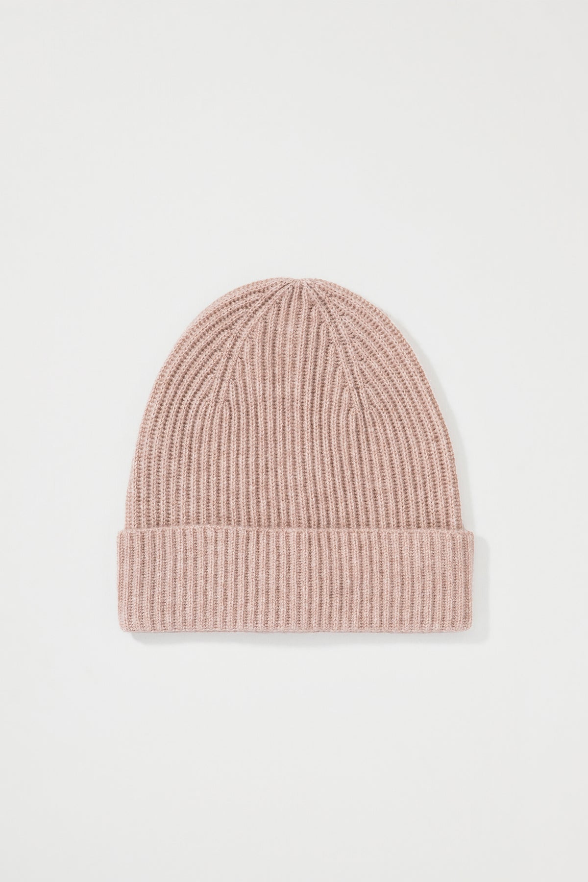 Unisex Cashmere Ribbed Beanie Hat in Sand laid flat, showing the ribbed knit texture and folded cuff detail