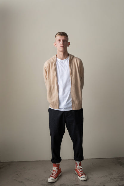 Unisex Cashmere Zip Hoodie in Vicuna worn open over a white tee, showing soft beige knit and ribbed hem