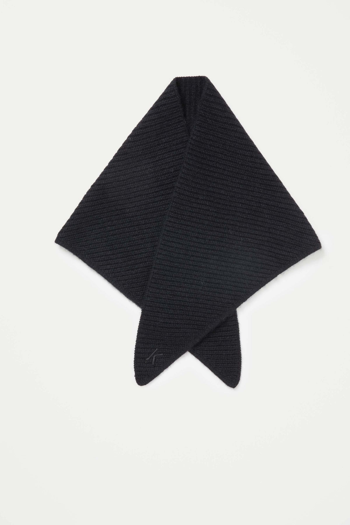 Knitted Cashmere Neck Tie in black laid flat in diamond shape, showing ribbed texture and embroidered logo on point