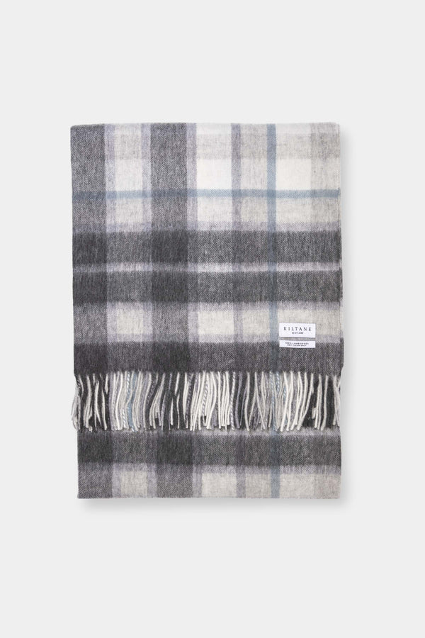 Kiltane Lambswool Throw in Ashley Blue Check, folded flat showing grey and cream plaid pattern with fringed edges