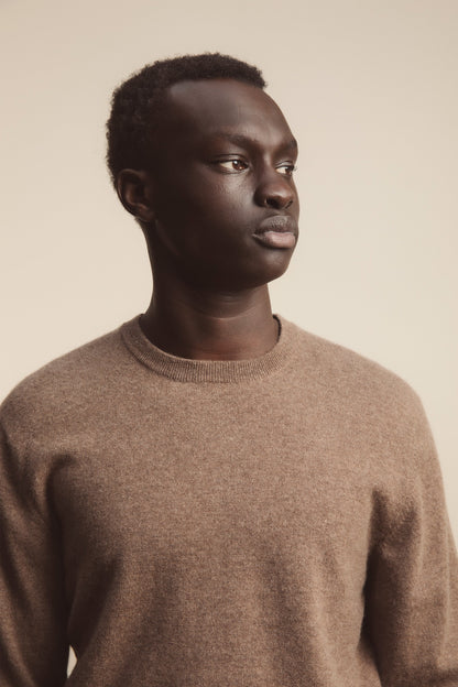Men's Cashmere Crew Neck Jumper in Squirrel brown, close-up of ribbed neckline and soft knit texture worn by model