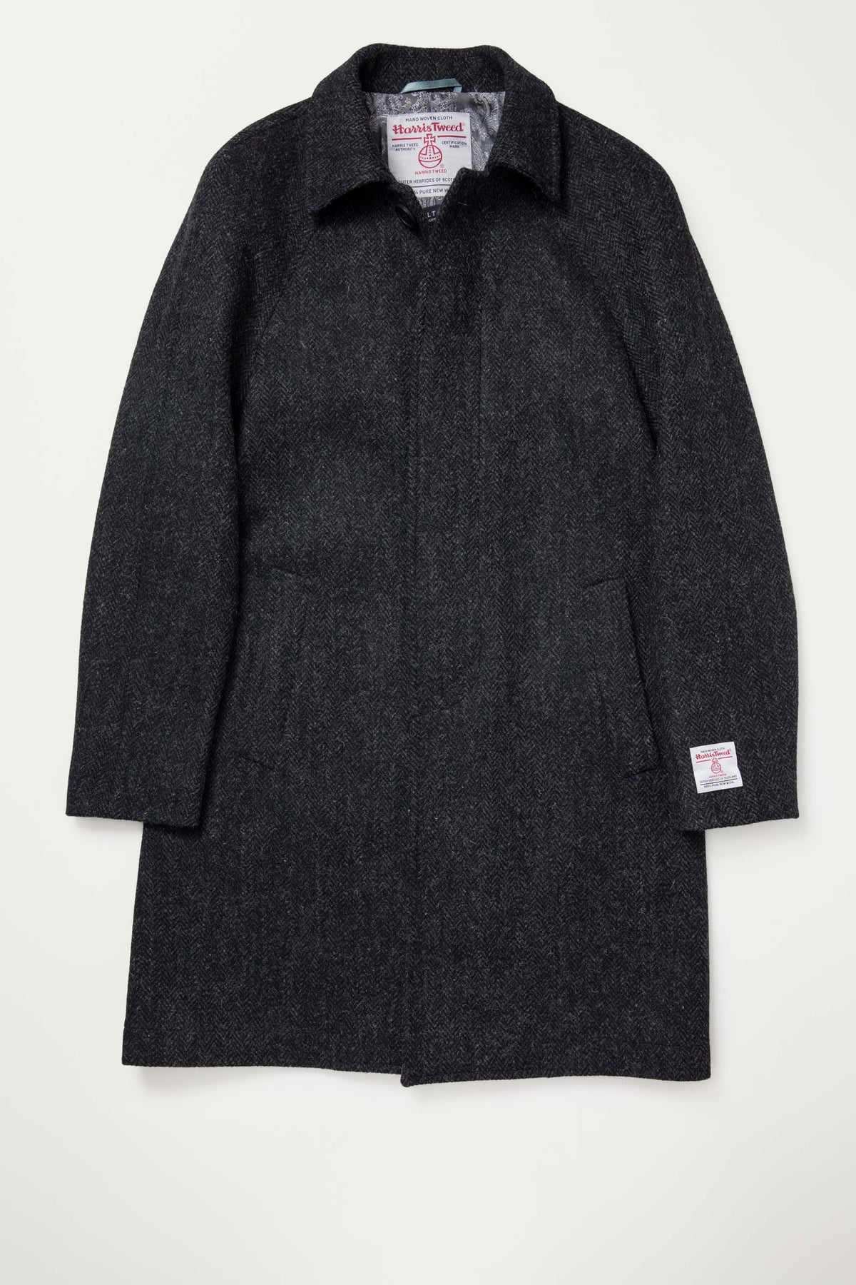 Men's Harris Tweed Ottavio Pea Coat in deep charcoal laid flat, showing herringbone weave, collar, and authenticity label on cuff