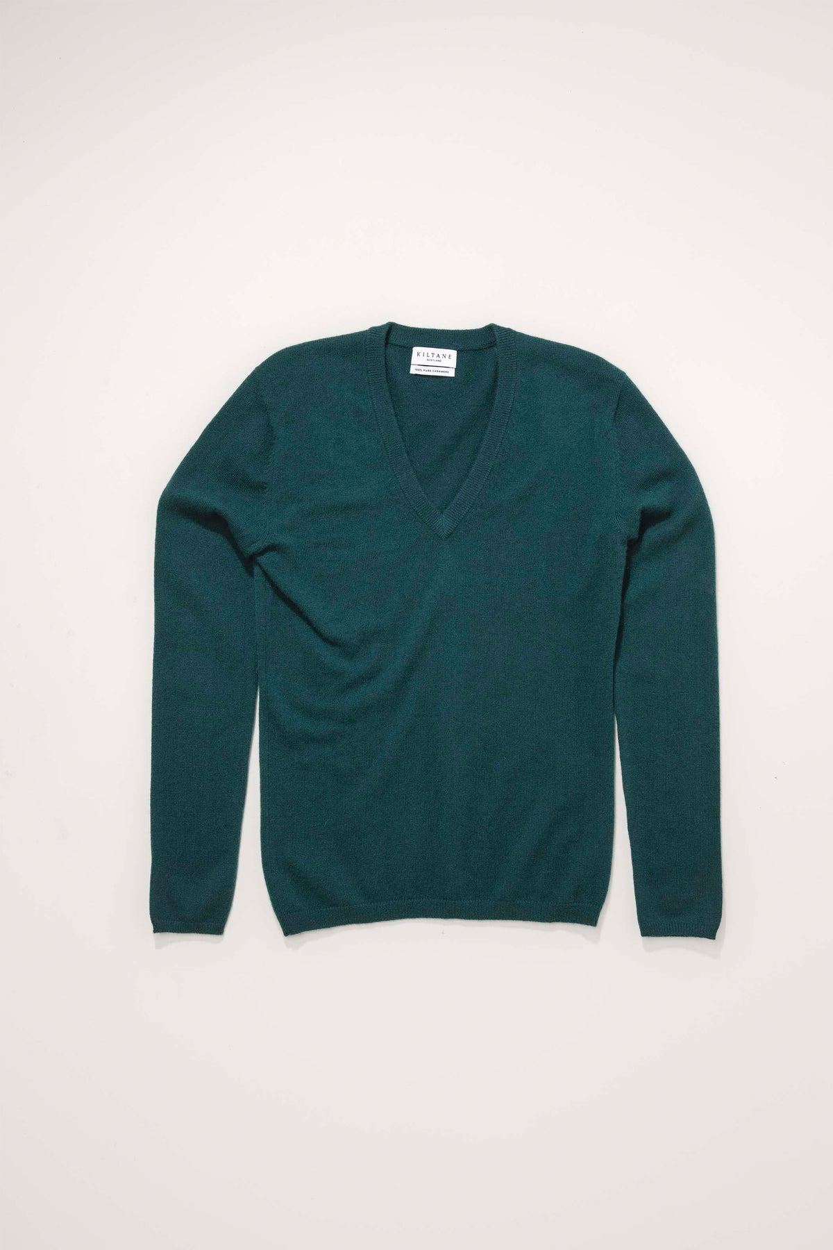 Kiltane Women's Cashmere V Neck Jumper in Forest Green laid flat, showing full front with deep V neckline and long sleeves