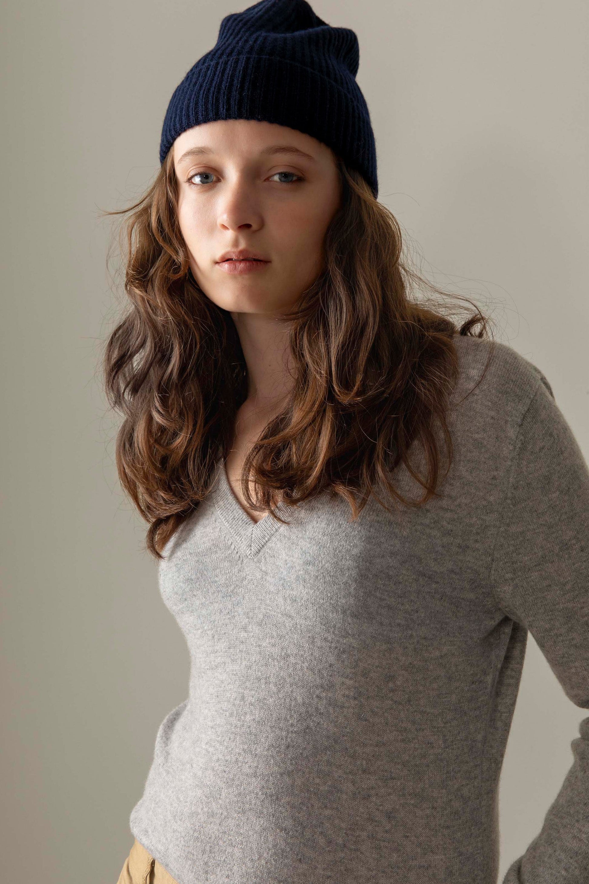 Women's Cashmere V Neck Jumper in light grey, soft lightweight knit with ribbed V-neckline, styled with navy beanie