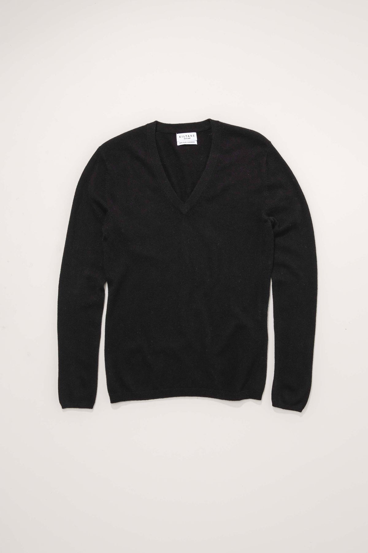Kiltane Women's Cashmere V Neck Jumper in black, flat lay front view showing the deep V neckline and long sleeves