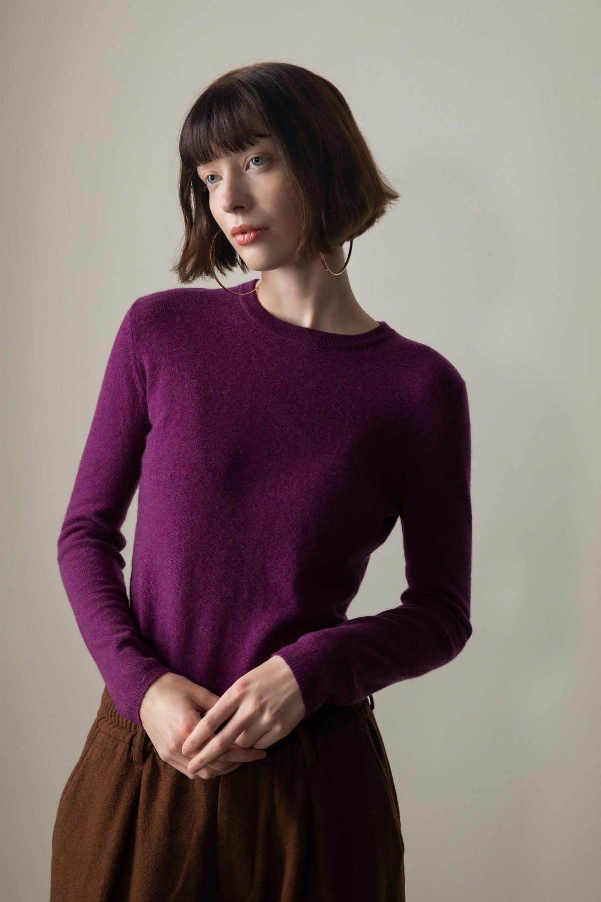 Model wearing the Women's Cashmere Crew Neck Jumper in Sloeberry, front view showing the slim fit and ribbed crew neckline