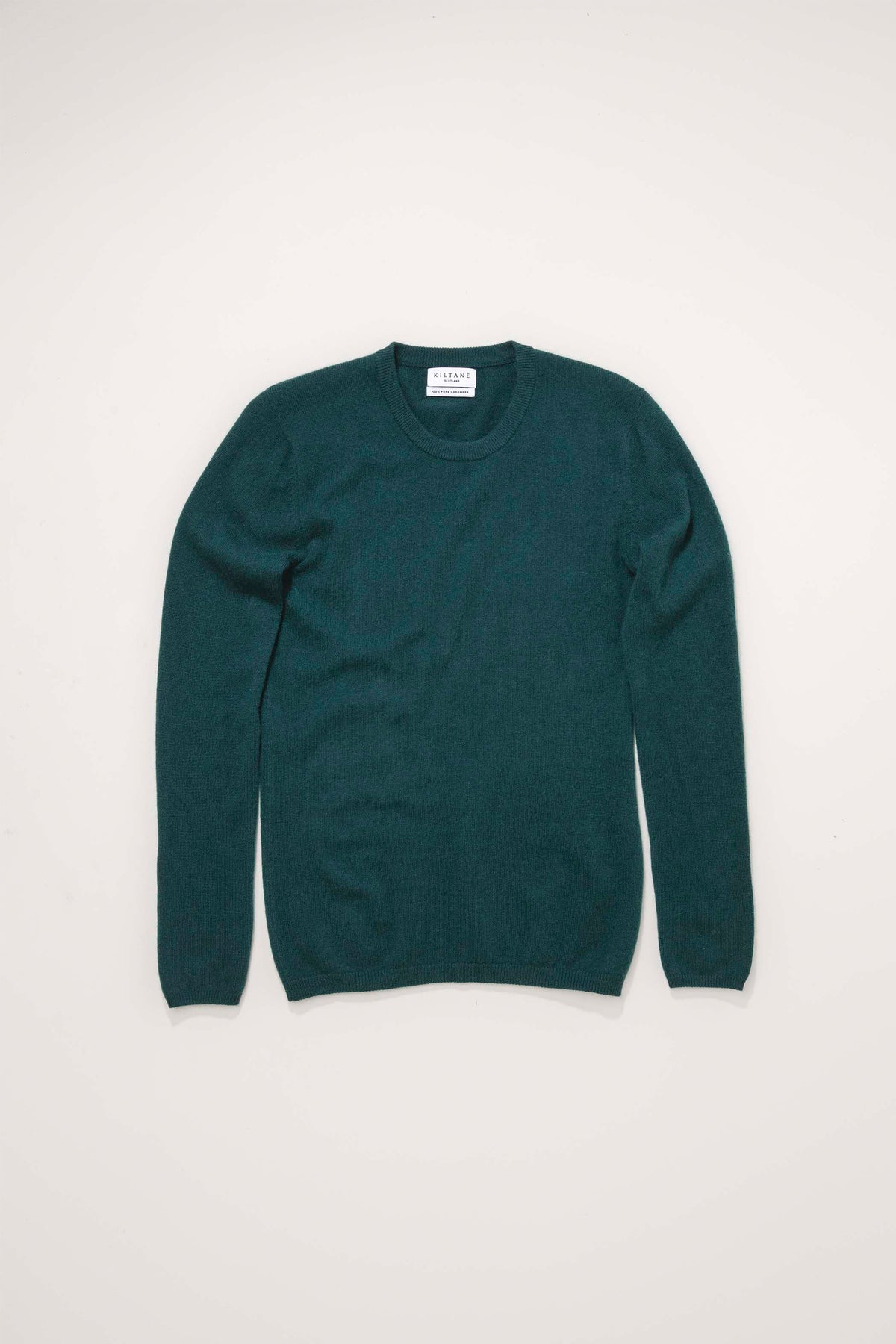 Kiltane Women's Cashmere Crew Neck Jumper in forest green, flat lay showing full front with ribbed cuffs and neckline
