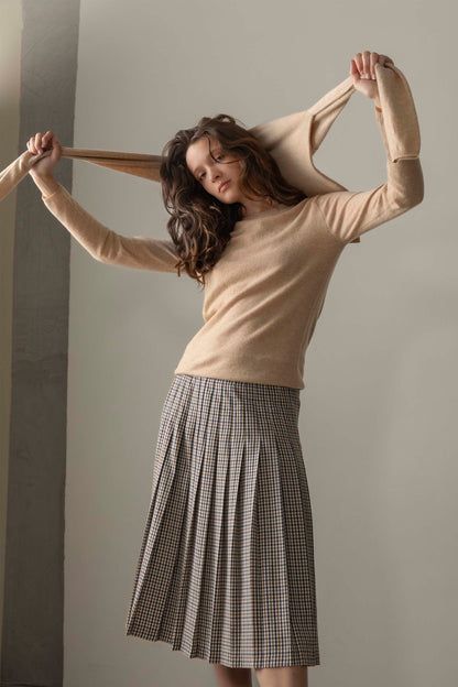 Women's Cashmere Crew Neck Jumper in Vicuna, slim-fit soft beige knit with round neckline and long sleeves, styled with a plaid skirt