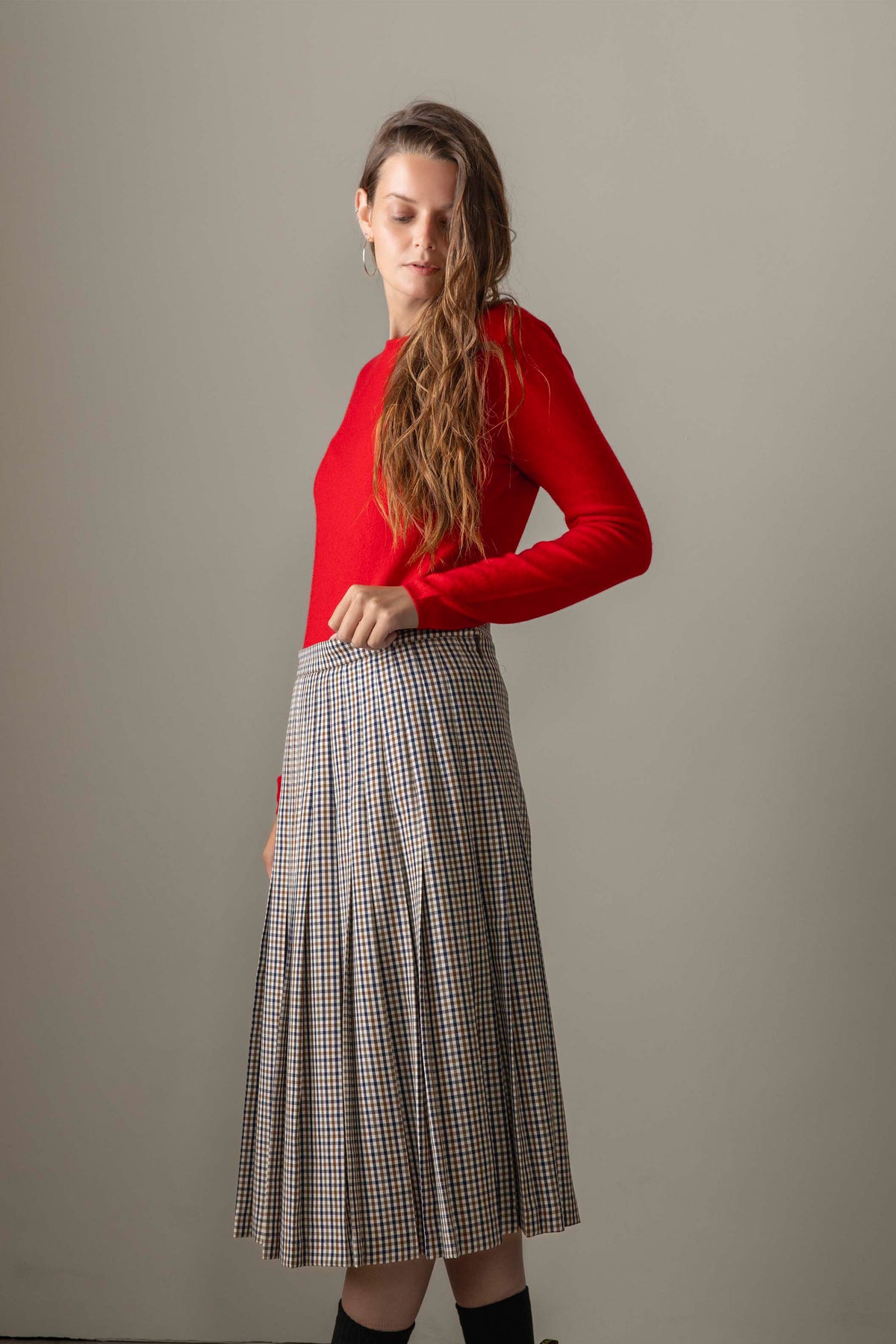 Women's Cashmere Crew Neck Jumper in red, slim-fit 100% cashmere knit styled with a check pleated midi skirt