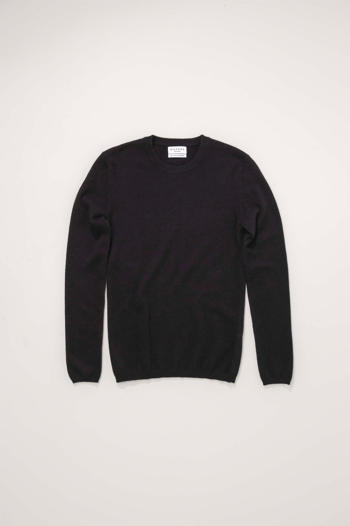 Kiltane Women's Cashmere Crew Neck Jumper in black, flat lay front view showing ribbed cuffs and neckline
