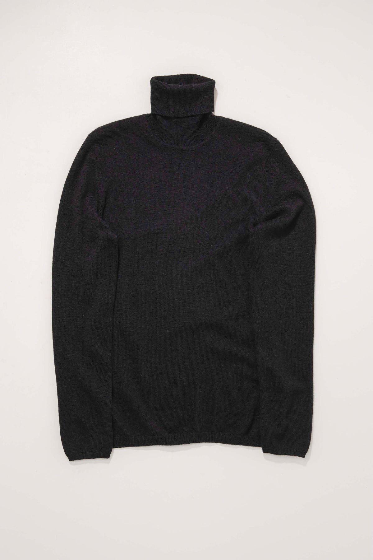 Women's Cashmere Polo Neck Jumper in black, flat lay front view showing slim fit and folded turtleneck collar