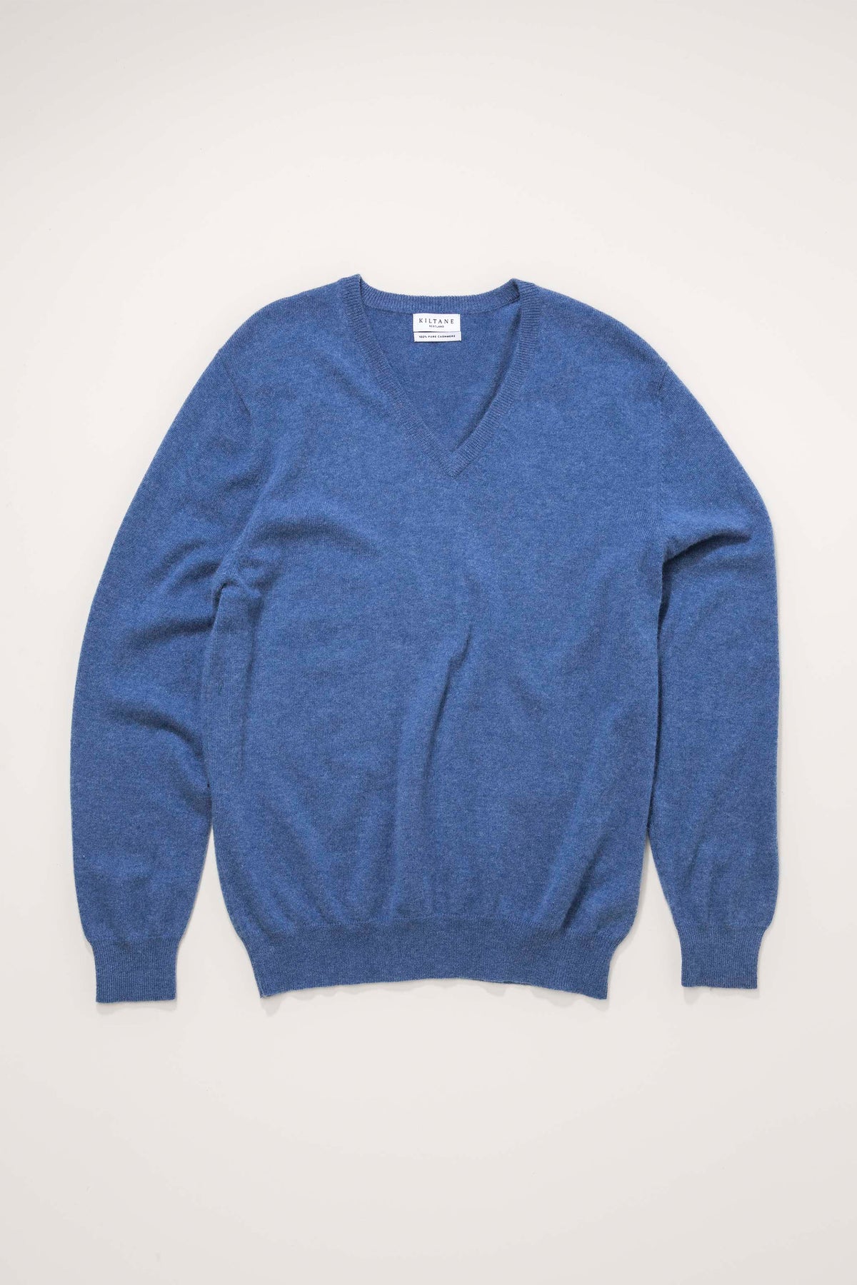 Men's Cashmere V Neck Jumper in Denim blue, flat lay front view showing soft knit texture and ribbed cuffs