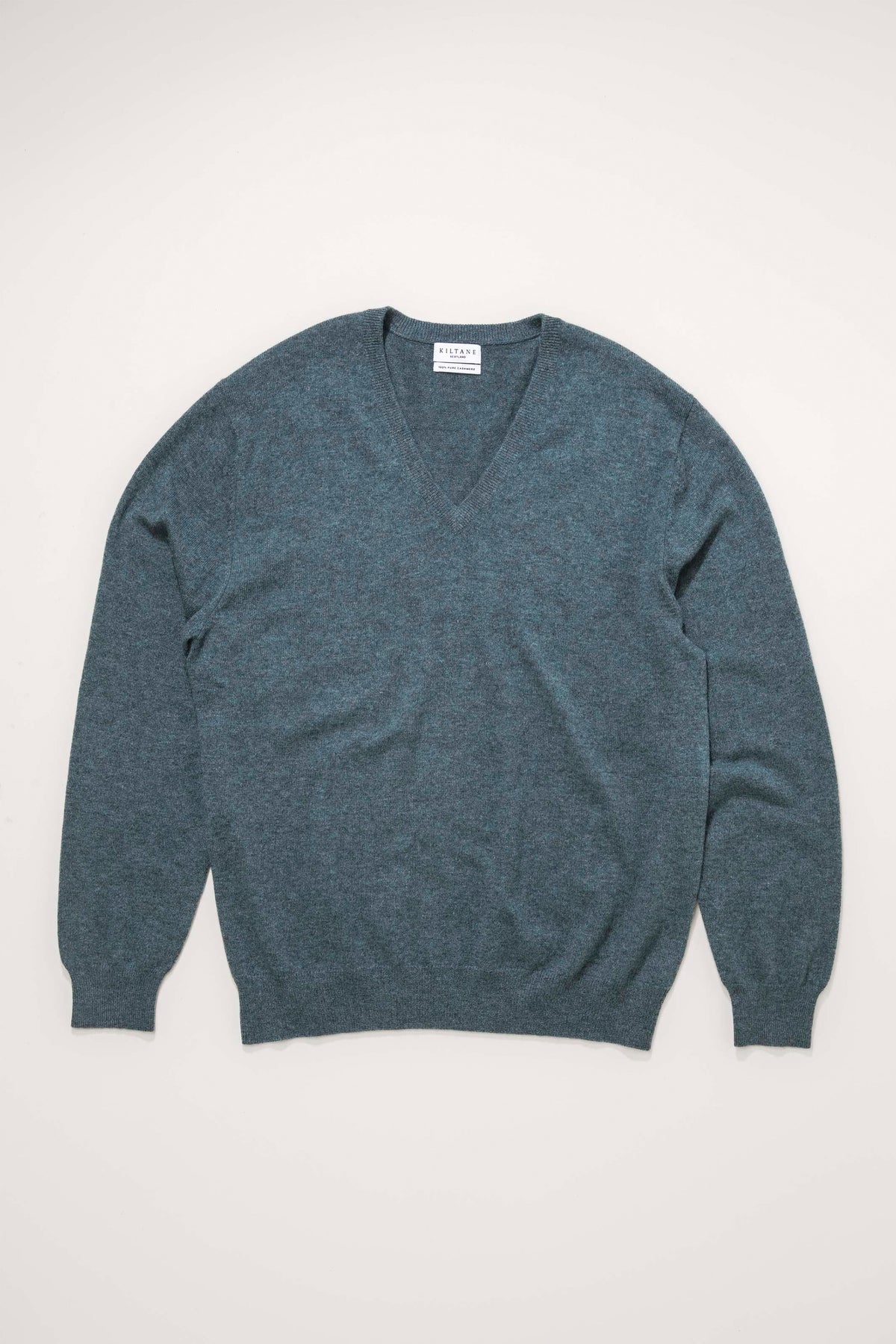 Kiltane Men's Cashmere V Neck Jumper in Haze Green laid flat, showing full front with ribbed cuffs and hem