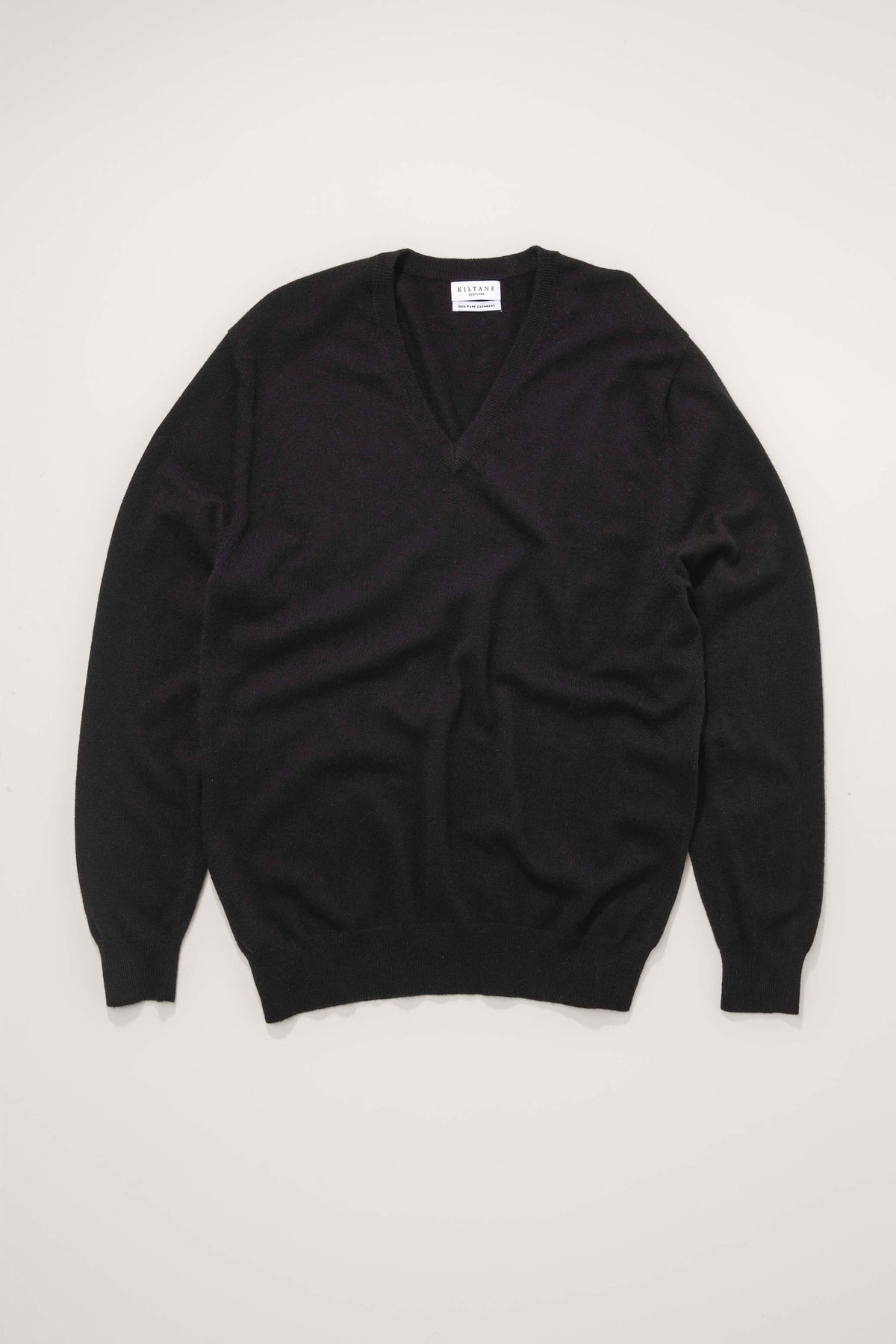 Kiltane Men's Cashmere V Neck Jumper in black, flat lay showing full front with ribbed cuffs and hem