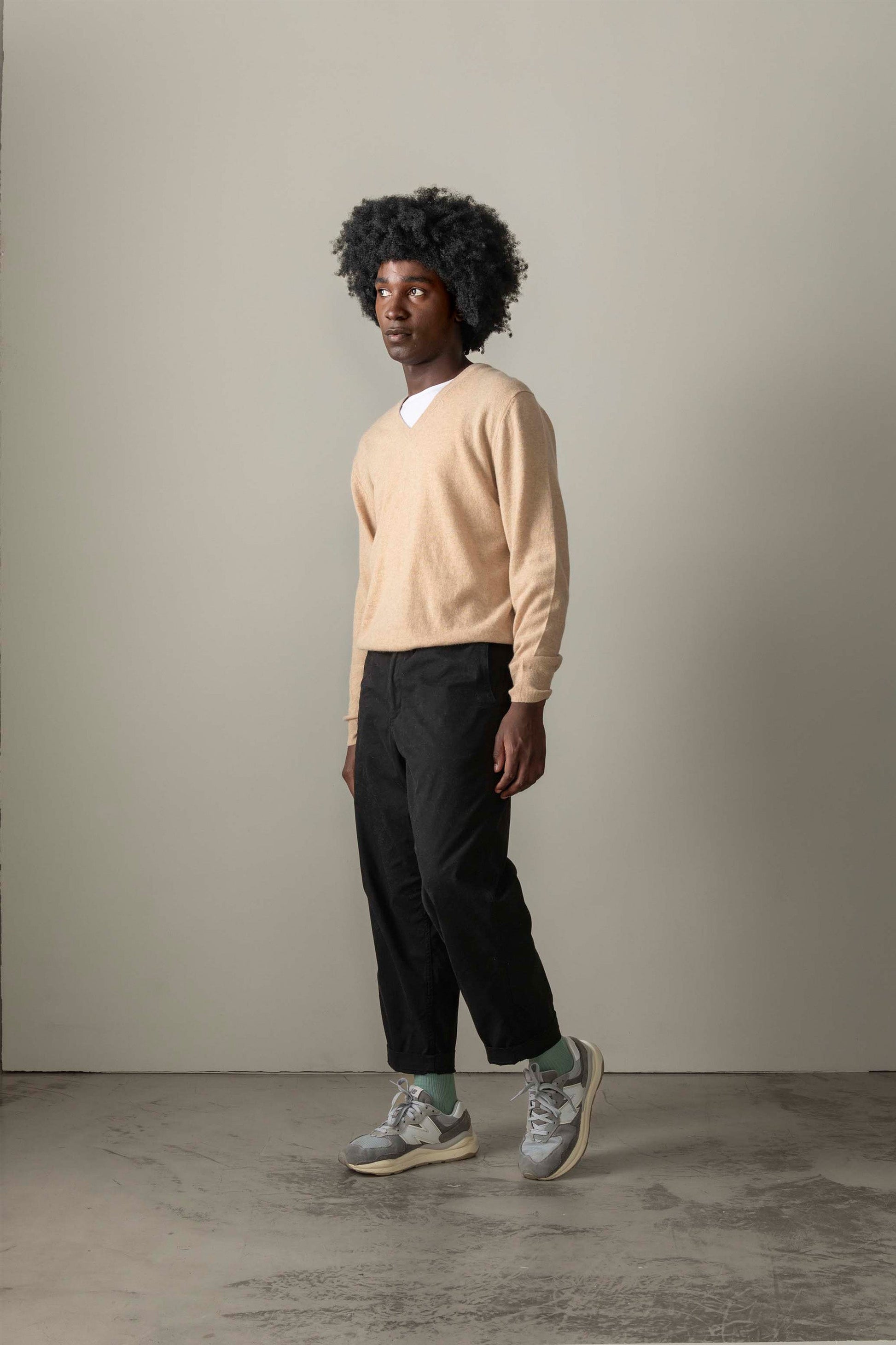 Men's Cashmere V Neck Jumper in Vicuna, a soft camel-toned lightweight knit worn over a white tee with relaxed fit