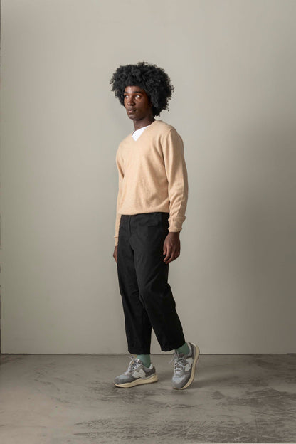 Men's Cashmere V Neck Jumper in Vicuna, a soft camel-toned lightweight knit worn over a white tee with relaxed fit