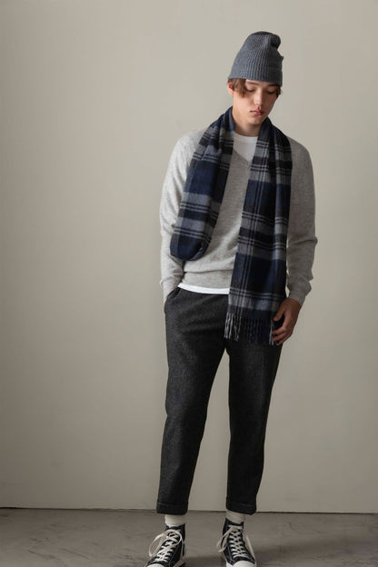 Men's Cashmere V Neck Jumper in light grey, styled on model with navy plaid scarf, grey beanie, and dark trousers