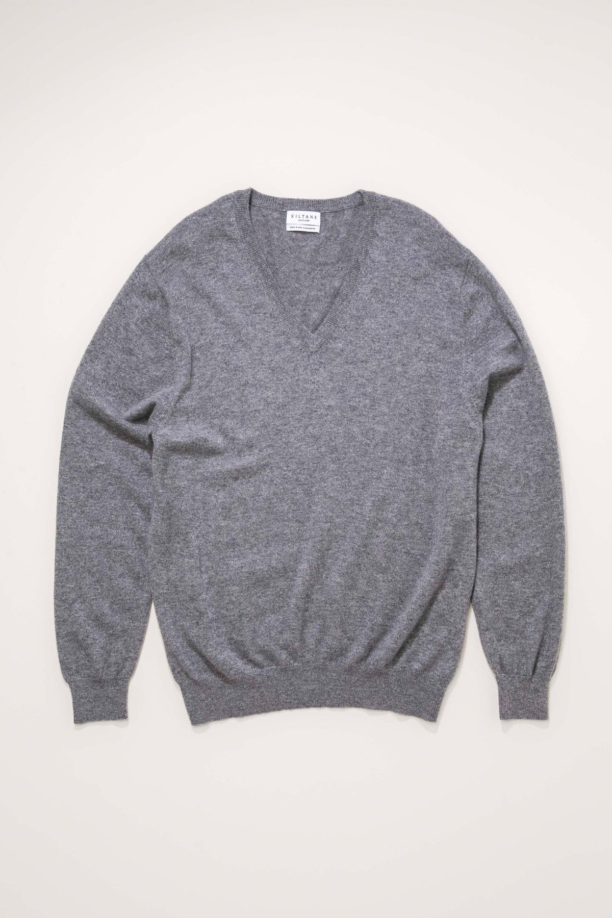 Kiltane Men's Cashmere V Neck Jumper in Derby Grey laid flat, showing front view with ribbed cuffs and hem