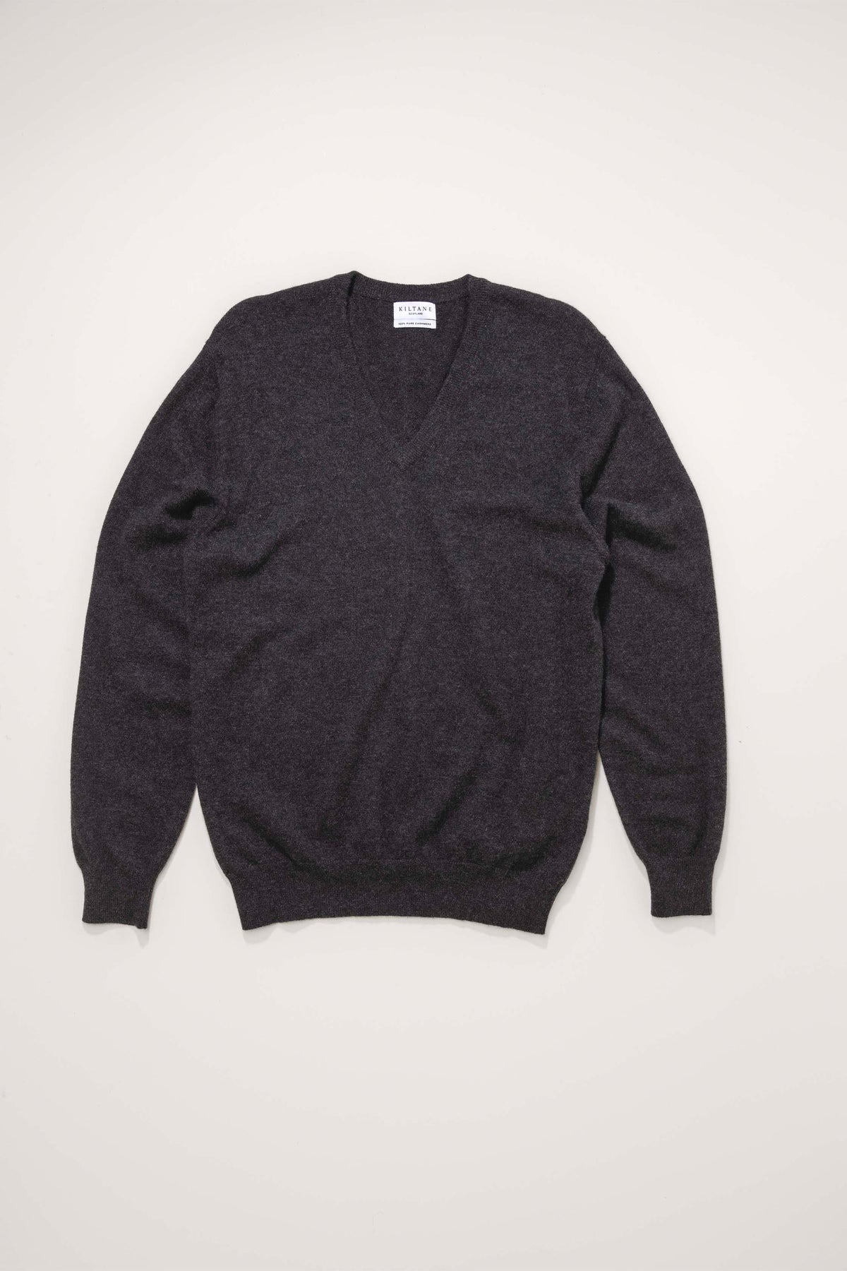 Kiltane Men's Cashmere V Neck Jumper in charcoal laid flat, showing full front view with ribbed cuffs and hem