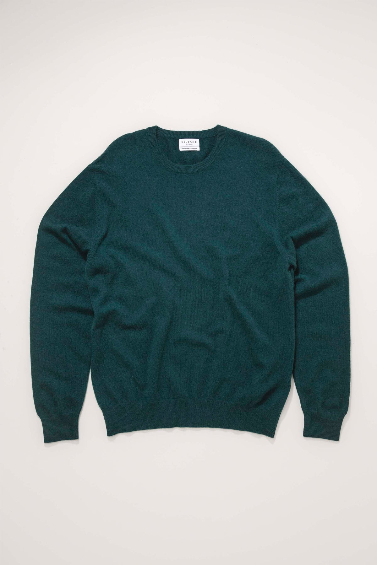 Kiltane Men's Cashmere Crew Neck Jumper in Richmond Green laid flat, showing front view with ribbed cuffs and hem