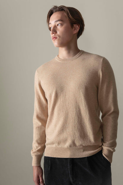 Men's Cashmere Crew Neck Jumper in Vicuna, a warm beige tone, with relaxed fit and ribbed cuffs, worn by model