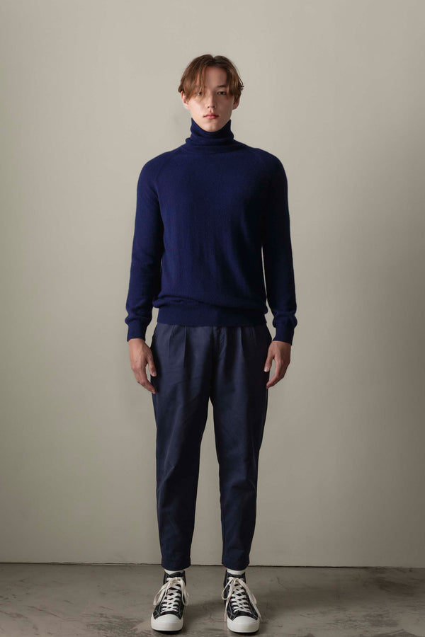 Men's Cashmere Roll Neck Jumper in navy, lightweight knit with slim fit, styled with navy trousers — full front view